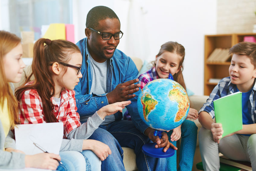 teacher and students with globe