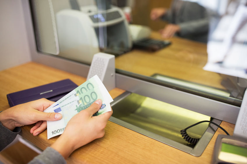 person with money at bank